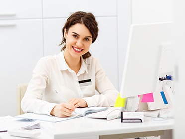 Smiling woman at a desk