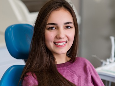 Young woman with braces in dental chair
