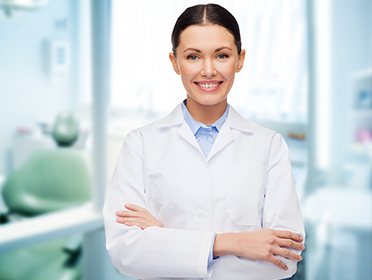 Smiling dentist in white coat