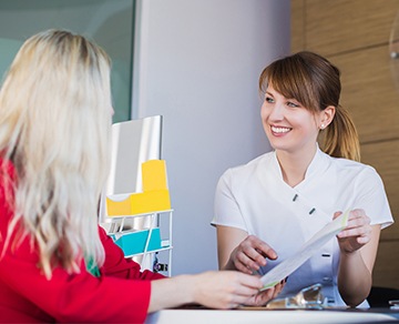 Team member and patient reviewing paperwork