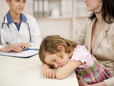 Mother and tired child talking to dentist