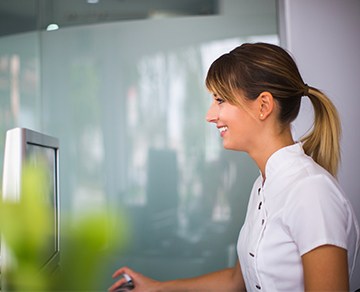 Smiling team member at dental reception